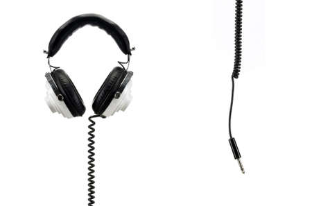 Black and white retro headphones isolated on white with jack hanging from the topの写真素材
