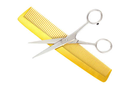 hairdressing scissors and comb isolated on whiteの写真素材