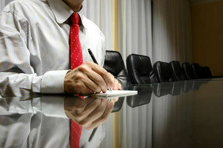 Business manager writing on blank paper in board room, business conceptの写真素材