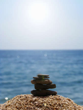 spa stones on the beach, sea and blue sky backgroundの写真素材