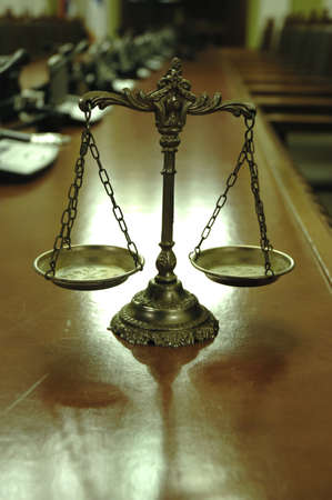 Symbol of law and justice in the empty conference room with microphones, law and justice conceptの写真素材