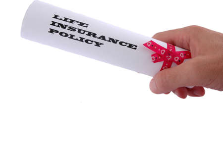 Life insurance policy in the hand on white backgroundの写真素材