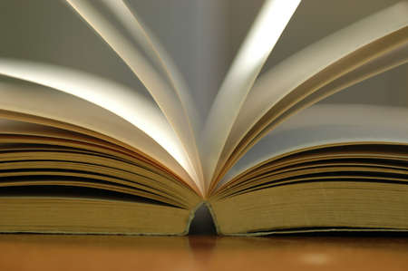 Closeup opened book on dark backgroundの写真素材