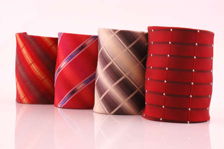 Four rolled colored ties  background, selective focusの写真素材