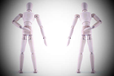 wooden dolls holding the hand due to back pain presents the impression of the role of a humans in...