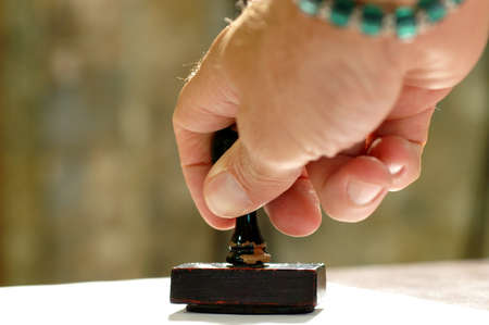 photo of Hand holding a rubber stampの写真素材