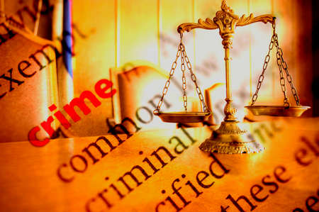 Dictionary definition of crime and Decorative Scales of Justiceの写真素材