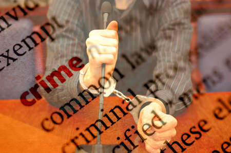 Dictionary definition of crime and hands with handcuffs, concept of Law and Justiceの写真素材