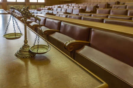 Symbol of law and justice in the empty courtroom, law and justice concept, focus on the scalesの写真素材