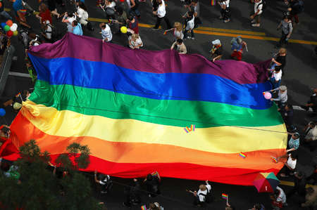 BELGRADE, SERBIA - SEPTEMBER 20, 2015: LGBT oriented people carrying a flag in Gay Pride Parade in Belgrade, Serbiaのeditorial素材