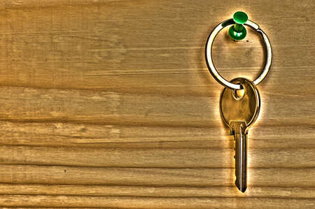 single key on a wooden table, HDR toningの写真素材