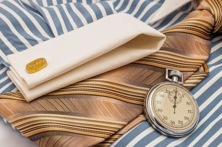 Blue and white cotton shirt, old Stopwatch and orange tie, time pressure concept