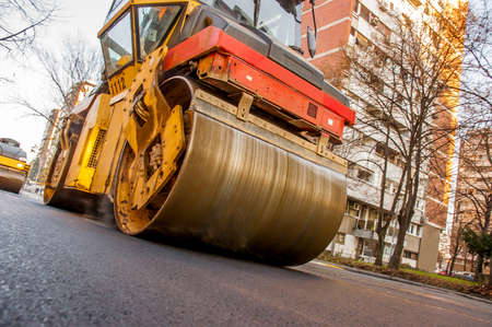 Steamroller asphalting city roads