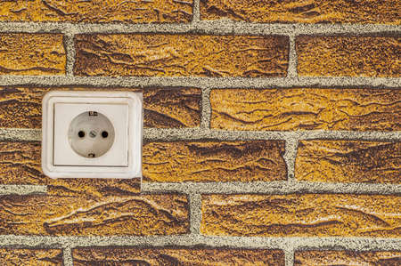 white power switch on the orange brick photo wallpaper backgroundの写真素材