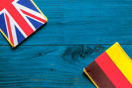 Germany and British flag on the blue wooden backgroundの写真素材