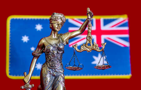 Statue of lady Justice and Australian flag on the red backgroundの写真素材