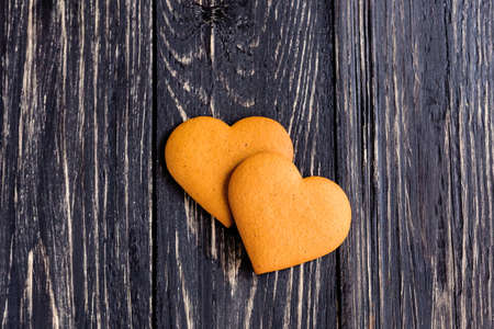 Heart shaped ginger valentine cookies on a wooden tableの写真素材