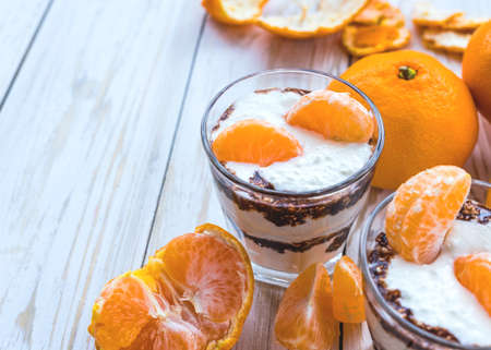 Whipped cottage cheese mousse with dark chocolate and mandarin. Healthy food concept. Selective...