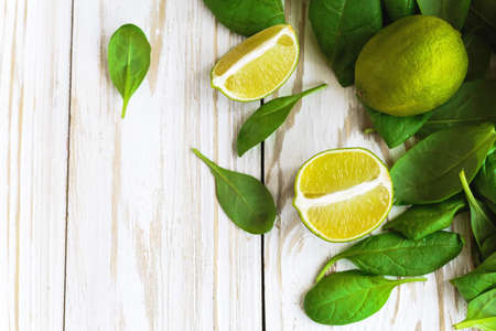 Wooden backgroung with healthy green spinach, lime and apple. Healthy food conceptの写真素材