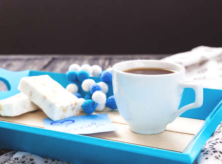 Egypt nougat with hazelnuts and cup of coffee in cosy blue tray. Breakfast conseptの写真素材
