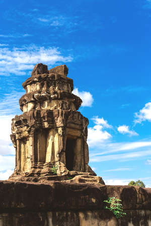 Temple in Angkor Wat Historical Complex, Siem Reap, Cambodia - December 6, 2016: Huge trees, galleries and walking tourists at sunny morning.の写真素材