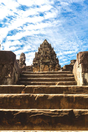 Temple in Angkor Wat Historical Complex, Siem Reap, Cambodia - December 6, 2016: Huge trees, galleries and walking tourists at sunny morning.の写真素材