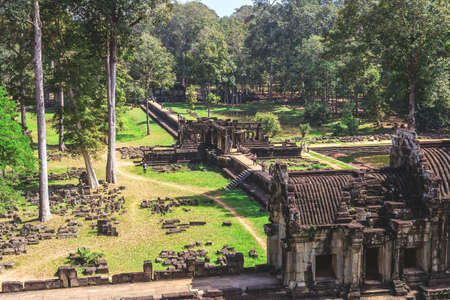 Angkor Thom, Baphuon Temple, Siem Reap, Cambodia - December 7, 2016: Tower and galleries and walking tourists at sunny morning.の写真素材