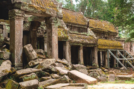 Tower, huge trees and galleries at sunny morning in Ta Prohm Temple, Siem Reap, Cambodia.の写真素材