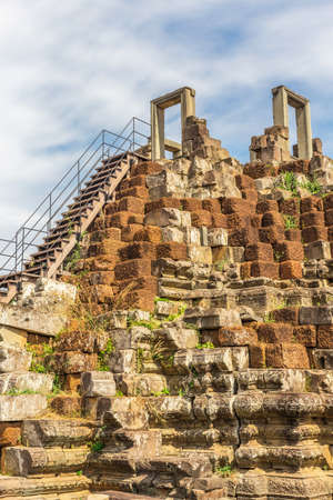 Tower and galleries and walking tourists at sunny morning in Angkor Thom, Baphuon Temple, Siem Reap, Cambodia.の写真素材