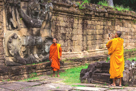Preah Khan Temple, Siem Reap, Cambodia - December 6, 2016: Buddist monks making pictures.のeditorial素材