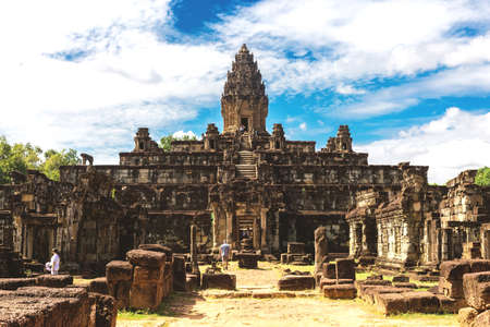 Temple in Angkor Wat Historical Complex, Siem Reap, Cambodia - December 6, 2016: Huge trees, galleries and walking tourists at sunny morning.のeditorial素材