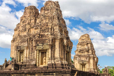 Temple in Angkor Wat Historical Complex, Siem Reap, Cambodia - December 5, 2016: Huge trees, galleries and walking tourists at sunny morning.のeditorial素材