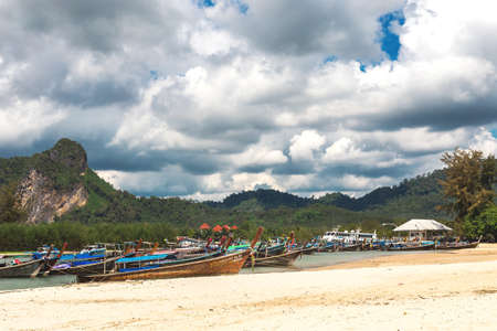 Ao Nang, Krabi Province, Thailand - December 16, 2016: Exotic beach. Sea, long tail boats, yachts and tropical forest.のeditorial素材