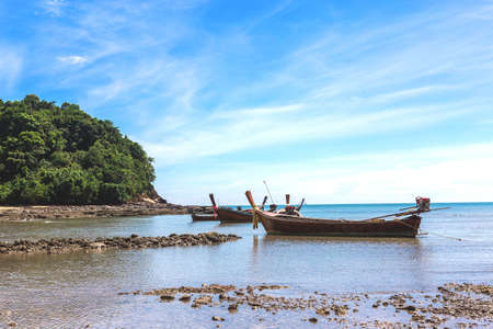 Fishing village at low tide - ethnic buildings and long tail boats. Koh Lanta Island, Krabi Province, Thailand.の写真素材