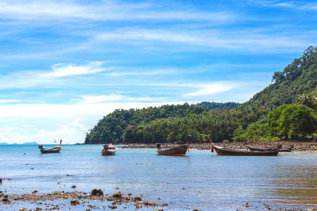 Fishing village at low tide - ethnic buildings and long tail boats. Koh Lanta Island, Krabi Province, Thailand.の写真素材