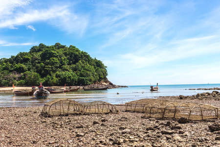 Fishing village at low tide - ethnic buildings and long tail boats. Koh Lanta Island, Krabi...