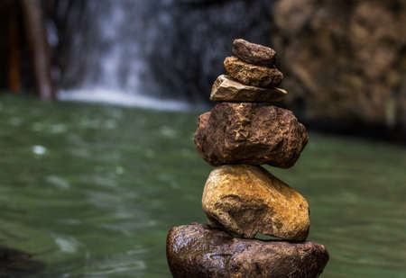 Stones balance near waterfall. Concept of harmony. Rock zen towerの写真素材