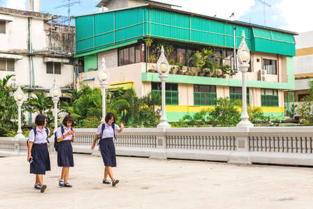 Krabi Town, Thailand - December 16, 2016: Students going home after school near Wat Kaew temple.のeditorial素材