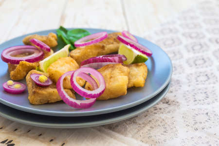 Crispy fried fish tilapia with lime and pickled onion. Selective focus. Closeup.の写真素材