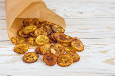 Homemade crispy Banana chips. Vegeterian concept.Traditional Indian and African snack.の写真素材