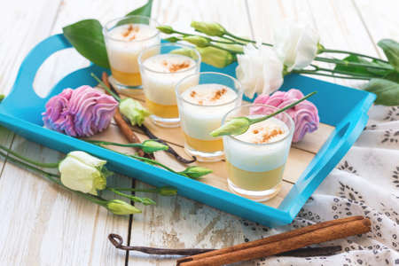 Traditional Homemade Eggnog with cinnamon and vanilla, marshmallow dessert and white eustoma flowers. Spring and easter conceptの写真素材