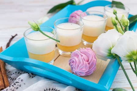 Traditional Homemade Eggnog with cinnamon and vanilla, marshmallow dessert and white eustoma flowers. Spring and easter conceptの写真素材