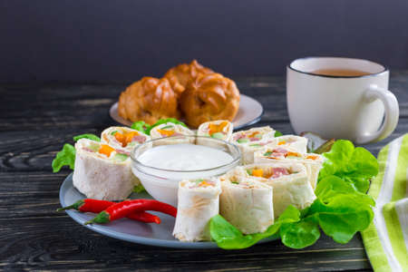 Pita rolls with maskarpone, ham, orange bell paper and cucumber. Served with green lettuce salad,...