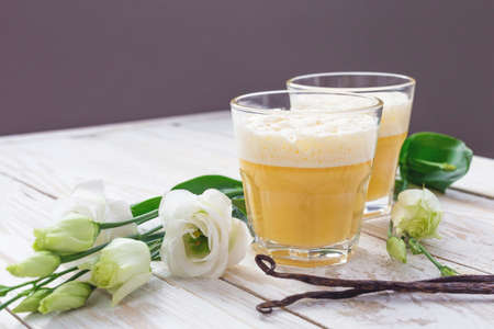 Traditional Homemade Eggnog with cinnamon and vanilla, and white eustoma flowers. Spring and easter conceptの写真素材