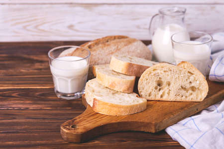 Sliced wheat bread, glass of fresh milk. Healthy food conceptの写真素材