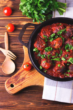 Traditional Italian beef meatballs, tomato sauce and parsley.  Selective focus. Wooden background.の写真素材