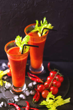 Bloody Mary cocktail with spicy smoked ground chili pepper, ice and selery.の写真素材
