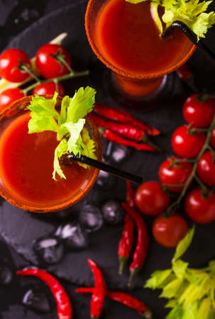 Bloody Mary cocktail with spicy smoked ground chili pepper, ice and celery.の写真素材