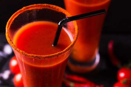 Bloody Mary cocktail with spicy smoked ground chili pepper, ice and celery.の写真素材
