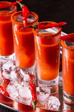 Bloody Mary cocktail with spicy smoked ground chili pepper, ice and celery.の写真素材